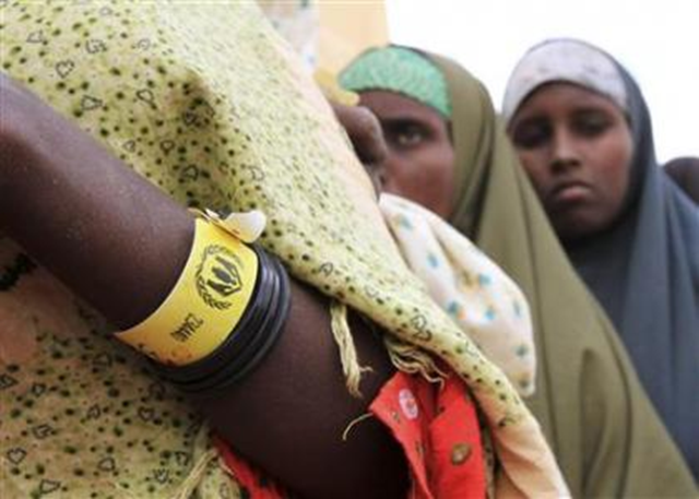 A Somali woman wears a yellow wristband for registered new arrivals at Ifo refugee camp in Dadaab July 10, 2011. More than 360,000 people fleeing civil unrest, drought and hunger are estimated to be living at Dadaab, the biggest refugee camp in the world, which was originally built for a capacity of 90,000 people but now has 380,000 refugees near the Kenya-Somali border. REUTERS / Noor Khamis