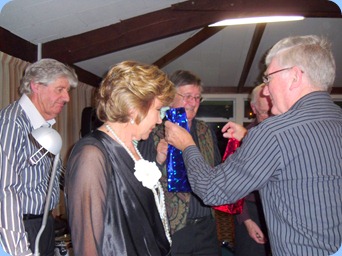 Gordon Sutherland, Club President and MC for the evening, handing out thank you gifts to The Music Makers Band. Photo courtesy of Club Secretary, Colleen Kerr.