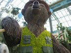 A bear wearing a floral vest at the Bellagio Conservatory and Botanical Garden.