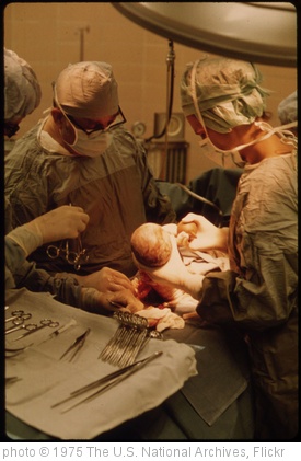'Dr. Howard Vogel, Left, Is Assisted by His Daughter, Dr. Ann Vogel, as They Perform the Last Caesarean Section of a New-Born Child in Union Hospital in New Ulm, Minnesota...' photo (c) 1975, The U.S. National Archives - license: http://www.flickr.com/commons/usage/
