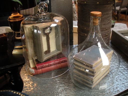 These glass covers can hold any number of decorative items. I love the dimpled metal surface they're resting on.