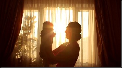 stock-footage-mother-plays-with-baby-before-window-in-silhouette stock-footage-mother-plays-with-baby-before-window-in-silhouette