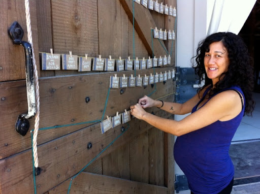 Jen from Jenny Pennywood designed all the stationery and textiles. Here, she hangs her escort cards. Baby Gemma was due not long after the wedding.