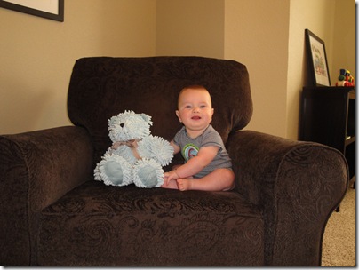 6.  Smiling in chair with bear