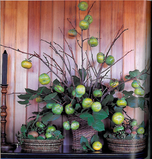 We lose a lot of greenery during the fall and winter, when the leaves begin to turn. It's refreshing to find a bright green display such as this one, which includes bowls filled with Granny Smith apples, and a wild arrangement of immature persimmons with magnolia leaves and peppercorn branches. This arrangement would like especially nice on a front porch. We lose a lot of greenery during the fall and winter, when the leaves begin to turn. It's refreshing to find a bright green display such as this one, which includes bowls filled with Granny Smith apples, and a wild arrangement of immature persimmons with magnolia leaves and peppercorn branches. This arrangement would like especially nice on a front porch.