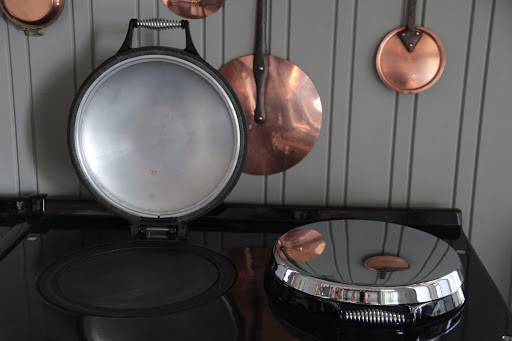 When this stove is fired up, the covers feel warm to the touch.  But, the surfaces beneath them are sizzling hot!
