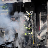 SFD firefighters responded to a report of a back porch fire Wednesday morning in Oak Park. Fire crews were called out just thirty minutes after the first in engine was put on "brown out" for forty-eight hours. Truck six, caring only ladders and gear, no water, arrived first on scene and was not able to assist in fighting the fire until the first engine arrived from East Sacramento, Engine 14, from the Alhambra and K Street area, according to Battalion Chief Jonathan Williams. Williams indicated that the time difference is significant in that fire literally doubles itself every minute and is even worse in our current hot and dry environment. One person suffered minor burns and transported to the hospital via paramedics. Two garages were lost and another out building, the porch of one home was burned and the back of the next door home started to catch fire but was quickly extinguished. News_120808_StructureFire_OP
