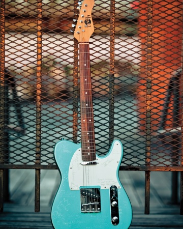 Friends and family autographed a teal guitar with a silver marker. It now hangs in the groom's office. Friends and family autographed a teal guitar with a silver marker. It now hangs in the groom's office.
