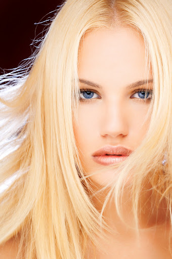 Beautiful blonde girl with hair fluttering in the wind