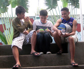Ninongs' Andrew, Ace and Jerome prepare to distribute money to students.