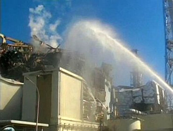 A fire truck sprays water at No 3 reactor of the Fukushima Daiichi nuclear power plant in Tomioka, Fukushima prefecture in this still image taken from a video by the Self Defence Force Nuclear Biological Chemical Weapon Defence Unit
