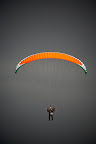 Paramotor pilot flying against grey cloud at SkySchool Spain