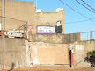 Anti-clerical squatter graffiti behind demolished workmen's cottages