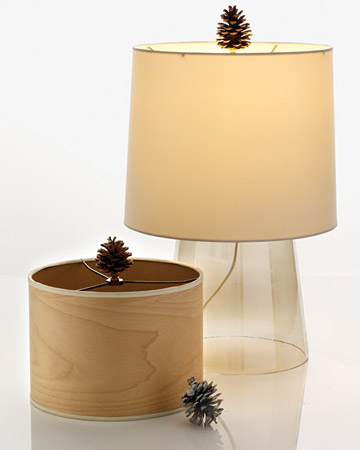 Finials -- he small piece that screws onto the top of a lamp's harp -- are given some attention when a pinecone is added to the top. Finials -- he small piece that screws onto the top of a lamp's harp -- are given some attention when a pinecone is added to the top.