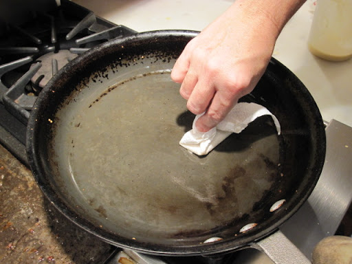 Brushing a little butter on the skillet; nonstick pans are foolproof, but not essential.