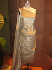 Metal thread silk one shoulder draped asymmetric cocktail dress with train from Marchesa.