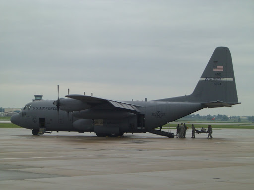 Military personnel load the mock patient onto the C-130 cargo plane. (Photo credit: Jennifer Moore)