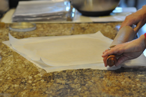 Layer the dough with parchment paper to make rolling easier.