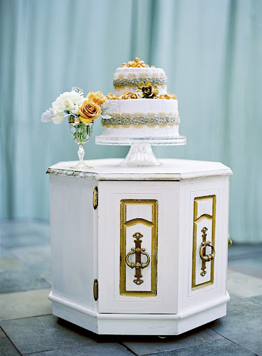 In place of a real cake, boxes filled with homemade salted caramel and decked in dupion silk and metallic ribbon were stacked on a custom two-tiered stand. In place of a real cake, boxes filled with homemade salted caramel and decked in dupion silk and metallic ribbon were stacked on a custom two-tiered stand.