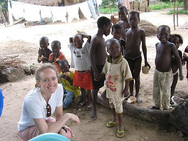 Accra, Ghana: Leanne Webster meets with children while visiting a microfinance farming community as part of the field work for the Ghana course. Photo credit: Meg Beiter