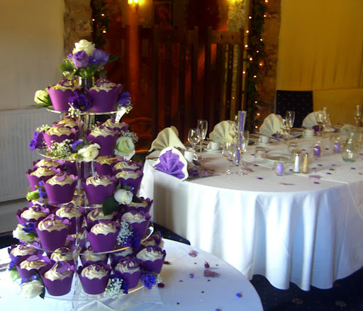 green hydrangea and purple wedding cakes with matching cupcakes