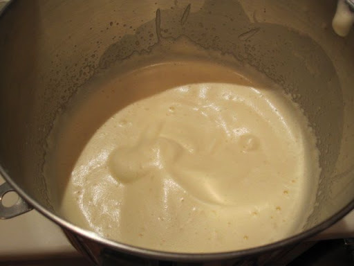 Whipping the warm egg mixture until it is the texture of soft whipped cream. Whipping the warm egg mixture until it is the texture of soft whipped cream.