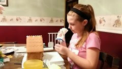Katie making a gingerbread House