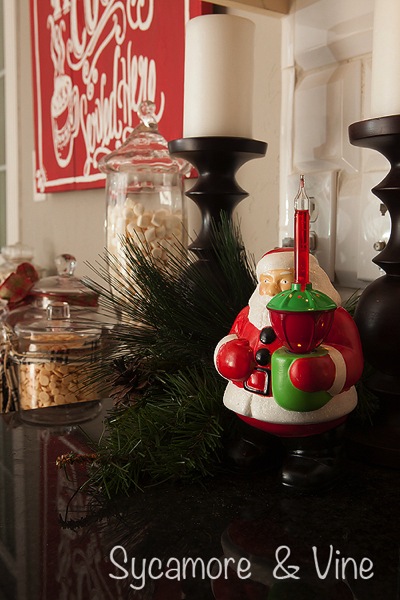 Vintage santa holding Christmas Bubble Light. A truly stunning Christmas Home Tour as part of the Christmas in the Country Blog Tour. This Plaid Inspired Country Christmas will knock your socks off. Features tours of the Living room, Dining Room and a Cocoa hot chocolate bar in the Breakfast room. There is so much inspiration for Christmas decorations in this one post. Be prepared to feel like you are cuddled up by the fire in a warm Northwoods comfy cottage! #country #Christmas #Plaid #Holiday decorating #Holiday ideas #Holidays #Christmas decor #Holiday decor Vintage santa holding Christmas Bubble Light. A truly stunning Christmas Home Tour as part of the Christmas in the Country Blog Tour. This Plaid Inspired Country Christmas will knock your socks off. Features tours of the Living room, Dining Room and a Cocoa hot chocolate bar in the Breakfast room. There is so much inspiration for Christmas decorations in this one post. Be prepared to feel like you are cuddled up by the fire in a warm Northwoods comfy cottage! #country #Christmas #Plaid #Holiday decorating #Holiday ideas #Holidays #Christmas decor #Holiday decor