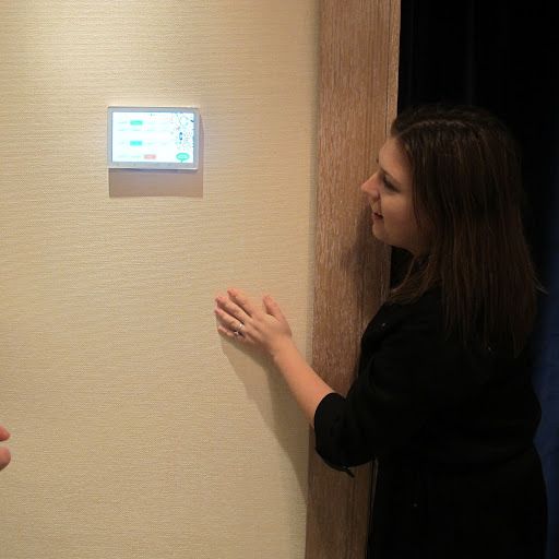 An employee explains how to use the dressing room display screen.