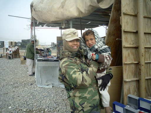 Stephanie Starkey holds a young Afghani child while serving in 2004-2005. Today, Starkey works as a counslor in the Springfield Vet Center. (Photo provided by: Stephanie Starkey)