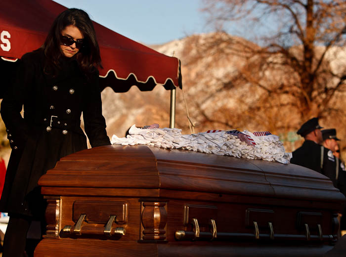 Erin Francom, widow of slain Ogden police Officer Jared Francom, has a quiet moment following the graveside service at the Ogden City Cemetery in Ogden, Utah, Wednesday, January 11, 2012.