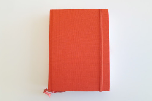 For their guestbook, a simple orange book was used. For their guestbook, a simple orange book was used.