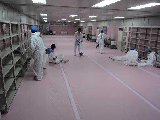 A rest area has been set up for workers at the Fukushima Daiichi nuclear plant, located in front of Main Anti-Earthquake Building, June 2011. Inside the rest area, walls and floors have been covered with a pink fabric, presumably for quick disposal after contamination. TEPCO