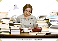stock-photo-middle-aged-woman-sitting-behind-the-desk-reading-books-75884707 stock-photo-middle-aged-woman-sitting-behind-the-desk-reading-books-75884707