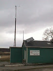 The 90 foot wind tower and solar hot water system at our original location in Plum Hollow.