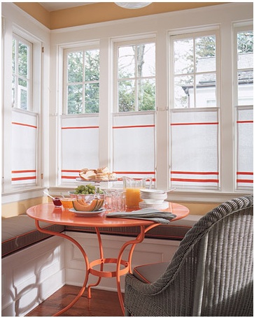 This combination of accent orange on the cushions and window treatment with the table makes a great photo.