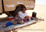 While I explore the dunes, Muhammad assumes his qat-chewing cigarette-smoking position all day in the shade of the truck.