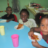 Peter, Estefani and Diana are enjoying their slices