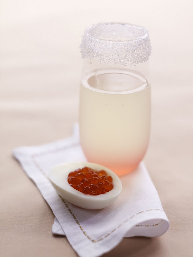 Introducing our starlight royal -- a delicious concoction of gin, lime juice, and champagne topped off with a splash of grenadine for a pink glow; a halved hard-boiled egg, de-yolked and filled with caviar, complements the drink nicely. (Martha Stewart Weddings) Introducing our starlight royal -- a delicious concoction of gin, lime juice, and champagne topped off with a splash of grenadine for a pink glow; a halved hard-boiled egg, de-yolked and filled with caviar, complements the drink nicely. (Martha Stewart Weddings)