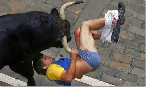 Diego Miralles gets gored by a bull on Estafeta street during the sixth running of the bulls of the San Fermin festival in Pamplona July 12, 2013. The runner, a 31-year-old man from Castellon, Spain, was gored three times. REUTERS/Susana Vera (SPAIN)<br /> Diego Miralles gets gored by a bull on Estafeta street during the sixth running of the bulls of the San Fermin festival in Pamplona July 12, 2013. The runner, a 31-year-old man from Castellon, Spain, was gored three times. REUTERS/Susana Vera (SPAIN)<br />