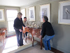 OK, Martha - You roll the carpet underneath the legs of the sideboard.  Fernando and Gyurme - lift carefully straight up!  Those are all really valuable antiques!