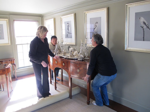 OK, Martha - You roll the carpet underneath the legs of the sideboard.  Fernando and Gyurme - lift carefully straight up!  Those are all really valuable antiques!