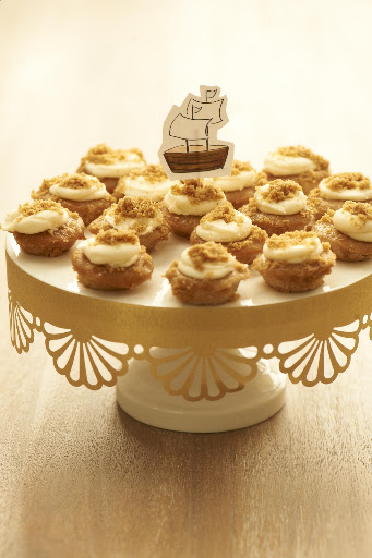 These bite-sized apple pie cupcakes from Baked by Melissa, www.bakedbymelissa.com, are a huge hit with kids and adults. Style them on a cake stand easily decorated with punched gold paper. These bite-sized apple pie cupcakes from Baked by Melissa, www.bakedbymelissa.com, are a huge hit with kids and adults. Style them on a cake stand easily decorated with punched gold paper.