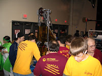 Engineers helping the students repair the robot