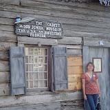 Carrie in front of schoolhouse.