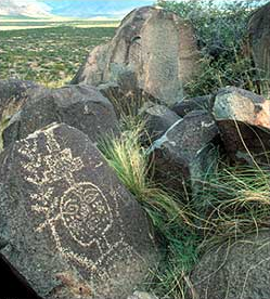 Mogollon petroglyph of a ceremonial dancer with rain cloud altar headdress and corn stalk wand, Three Rivers Petroglyph site, New Mexico. desertusa.com