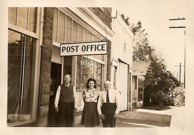 William Proctor, Margaret Lucker and William Reid in front of the Post Office in the Ellis Block in Rainier, Oregon