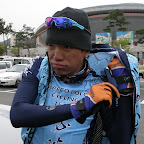 Loh Sea Keong from the Marco Polo Cycling Team putting on some warm clothing against the cold in the Tour de Korea 2010. (photo: Remko Kramer)