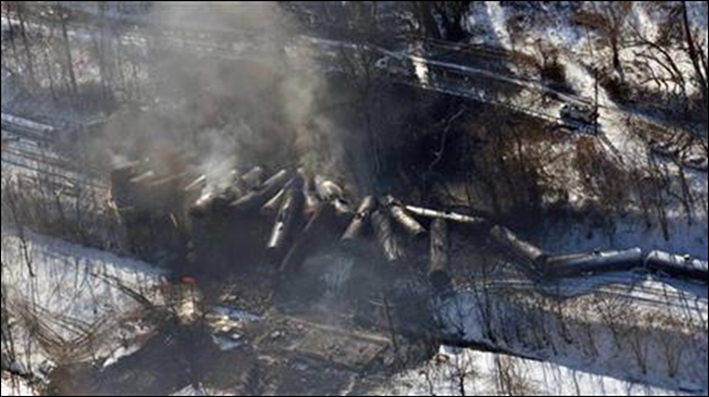 This aerial 17 February 2015 file photo photo made available by the Office of the Governor of West Virginia shows a derailed train in Mount Carbon, West Virginia. As investigators in West Virginia and Ontario pick through the wreckage from the latest pair of oil train derailments to result in massive fires, U.S. transportation officials predict many more catastrophic wrecks involving flammable fuels in coming years absent new regulations. Photo: Office of the Governor of West Virginia / Steven Wayne Rotsch / AP Photo