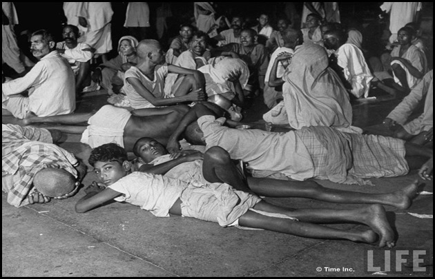 People waiting in railroad station trying to escape city after bloody rioting between Hindus and Muslims[3]